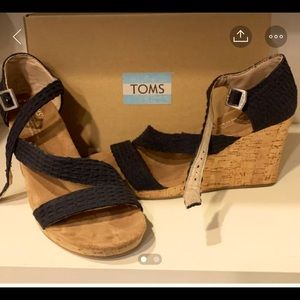Tom’s size8.5 black wedge with cork bottom.